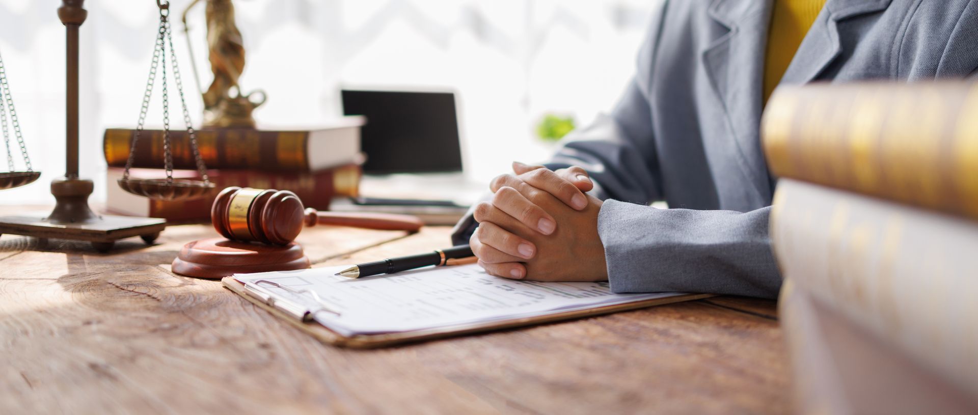 Lawyers consultation and conference discussing legal matters at a desk with a gavel.