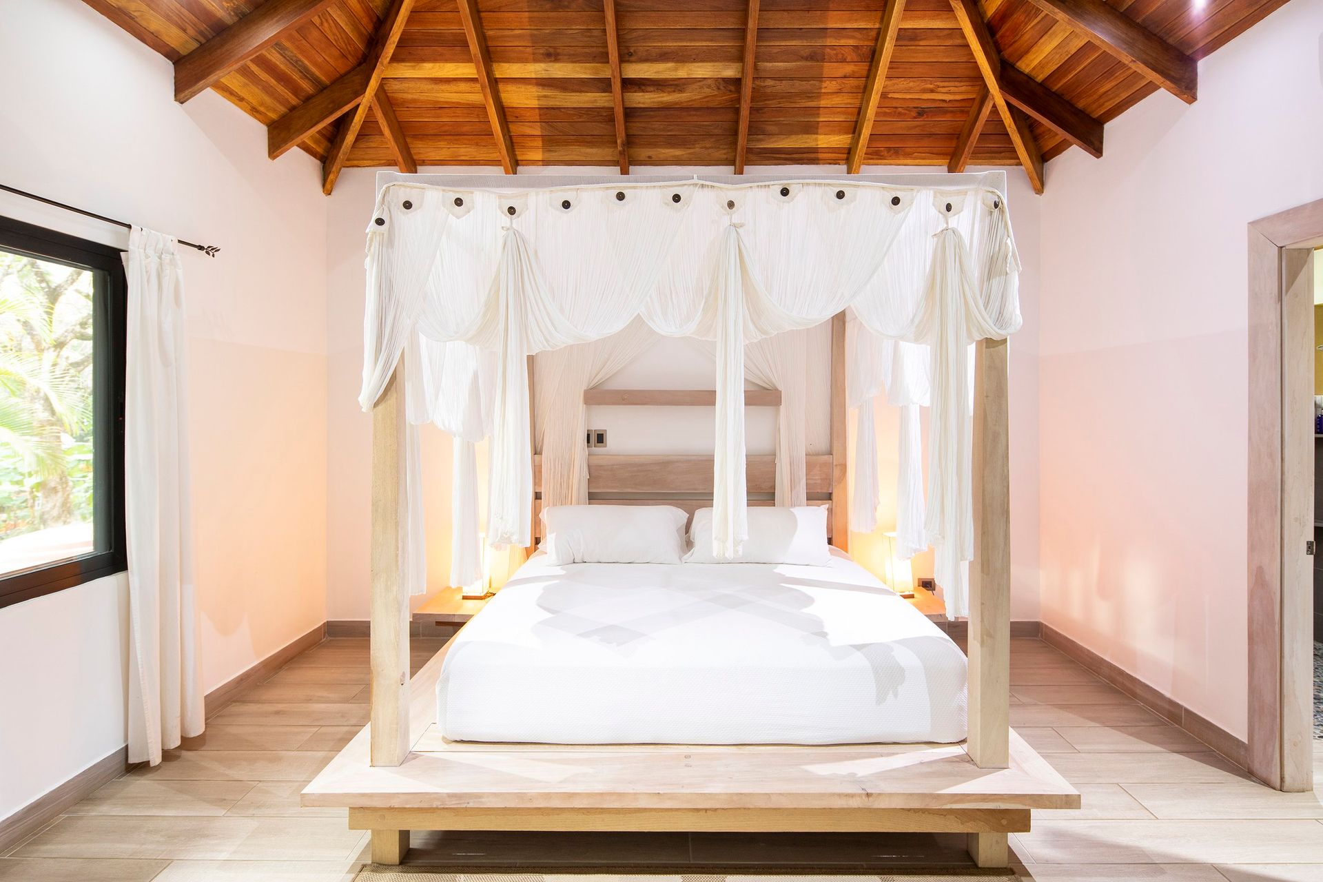 A bedroom with a canopy bed and a wooden ceiling