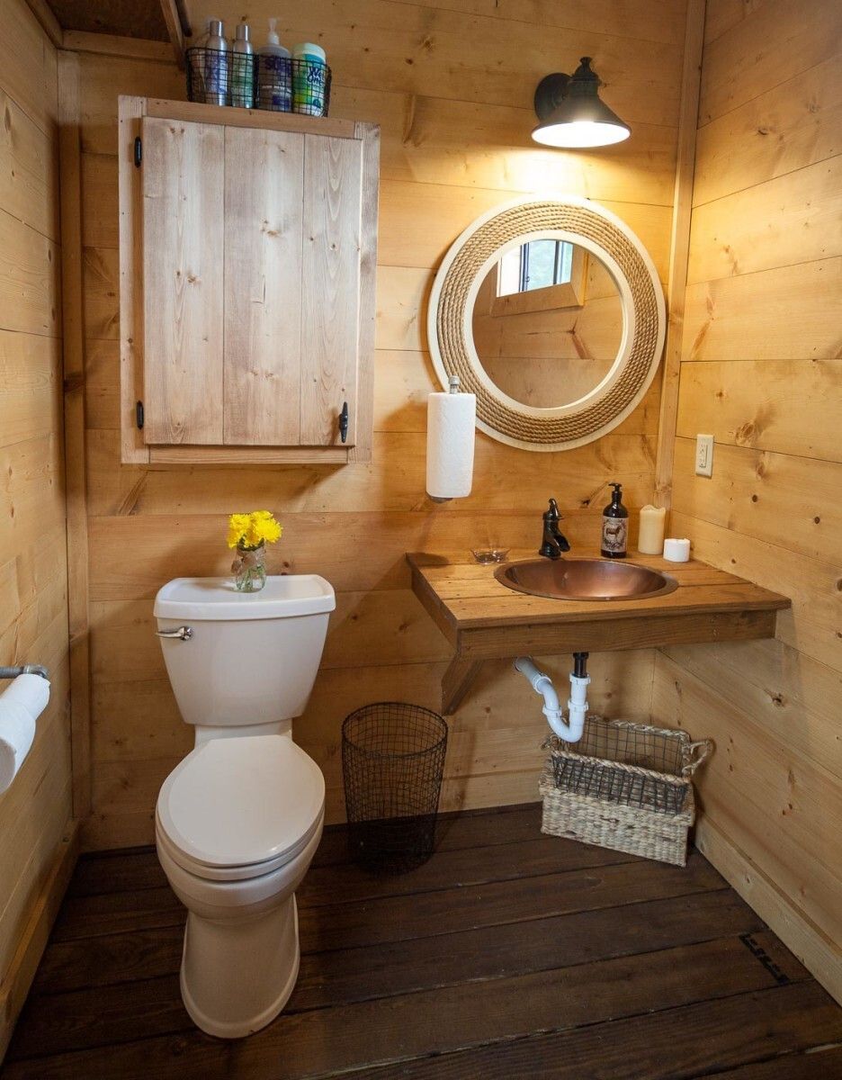 A bathroom with a toilet a sink and a mirror