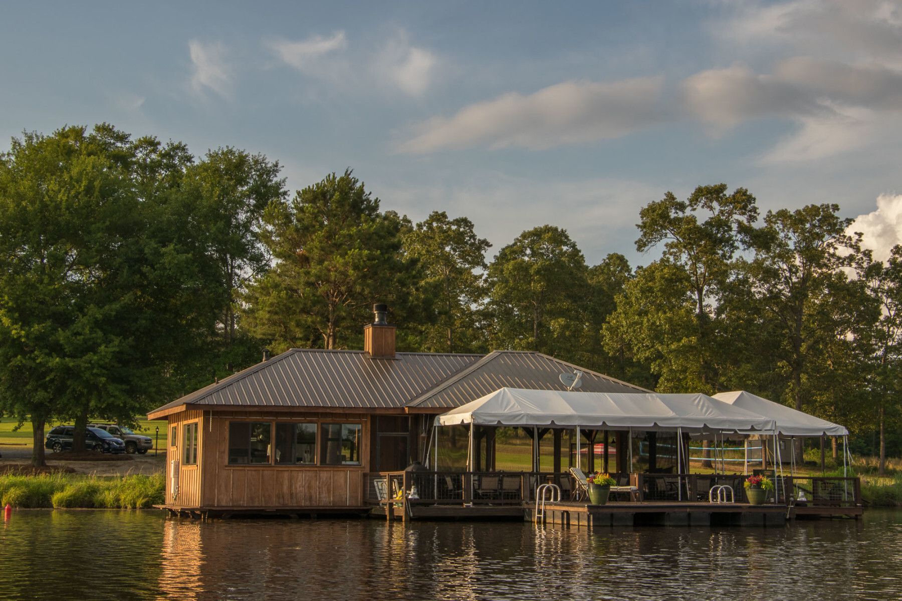 A small house is floating on top of a body of water.