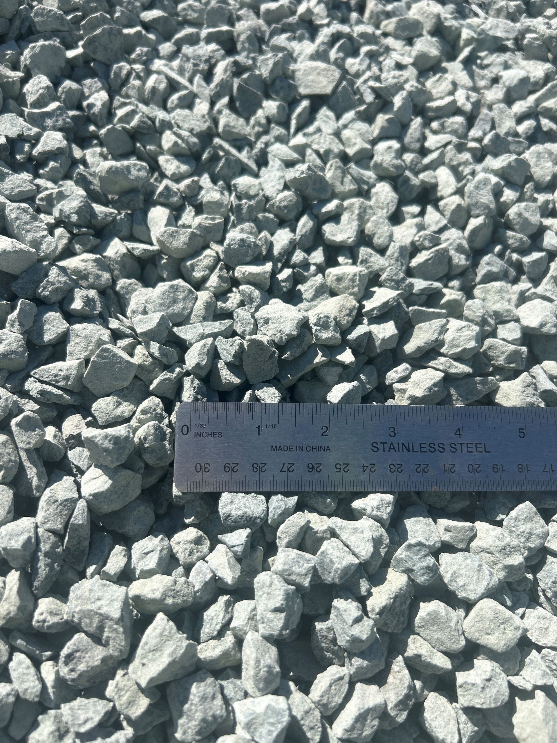 Gray gravel with a ruler laid across it for scale.