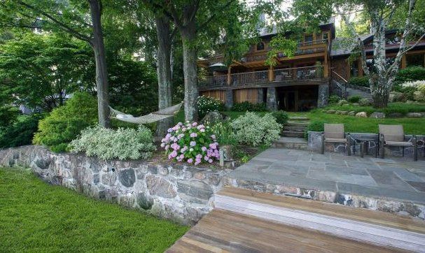 There is a hammock in the backyard of a house.