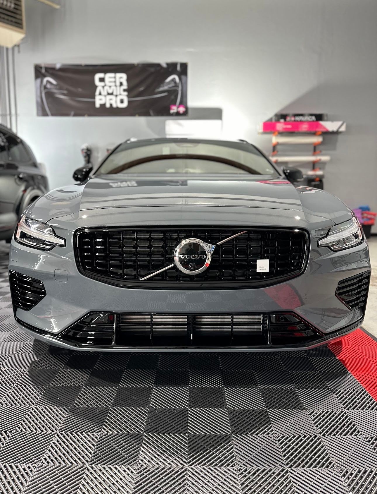 A volvo s60 is parked in a garage.