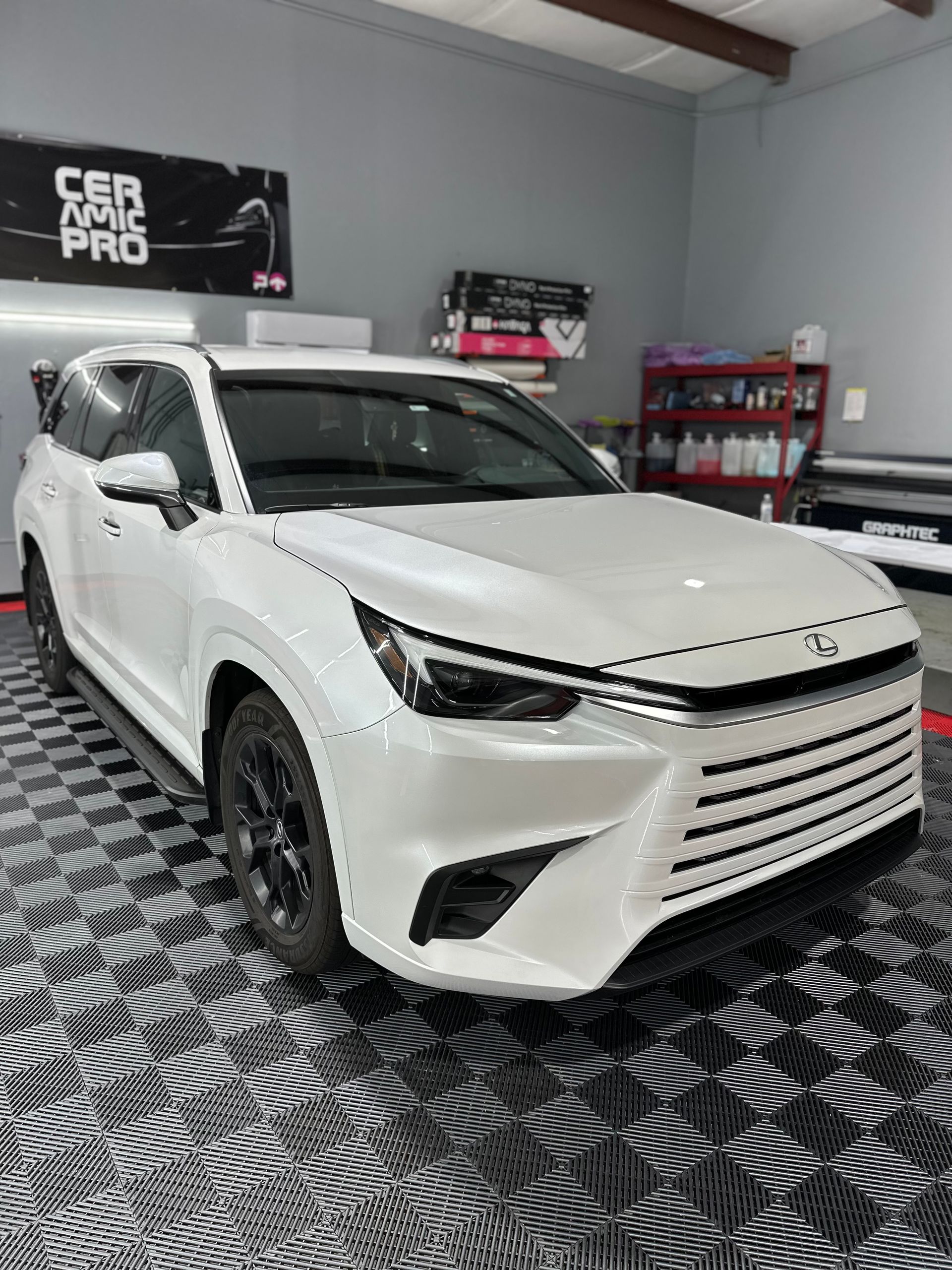 A white car is parked in a garage.