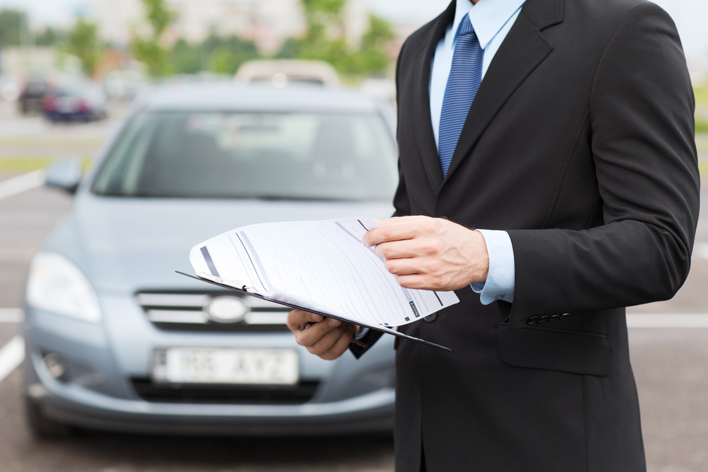 Question mark icon with car key and insurance policy visually representing rental car FAQ
