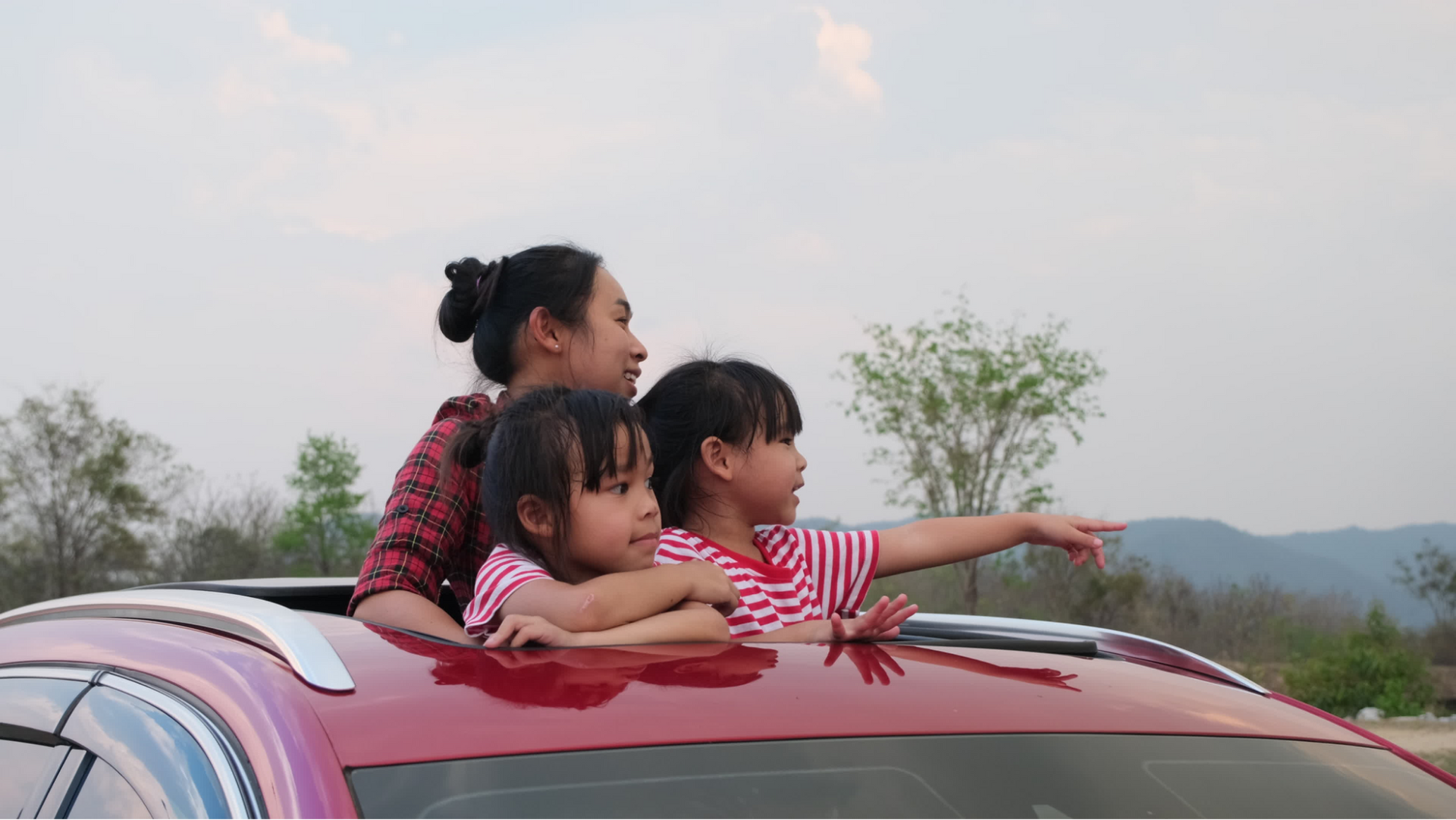Children smiling from backseat during a family winter drive near Sydney