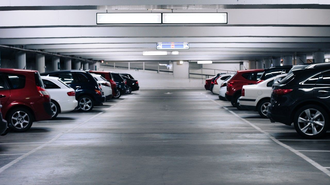 A lot of cars are parked in a parking garage.