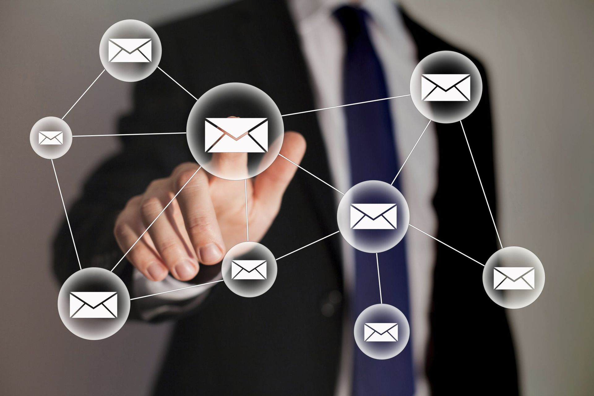 Businessman touching a digital email network interface with envelope icons connected by lines