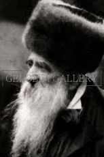 A black and white photo of a man with a beard wearing a fur hat.