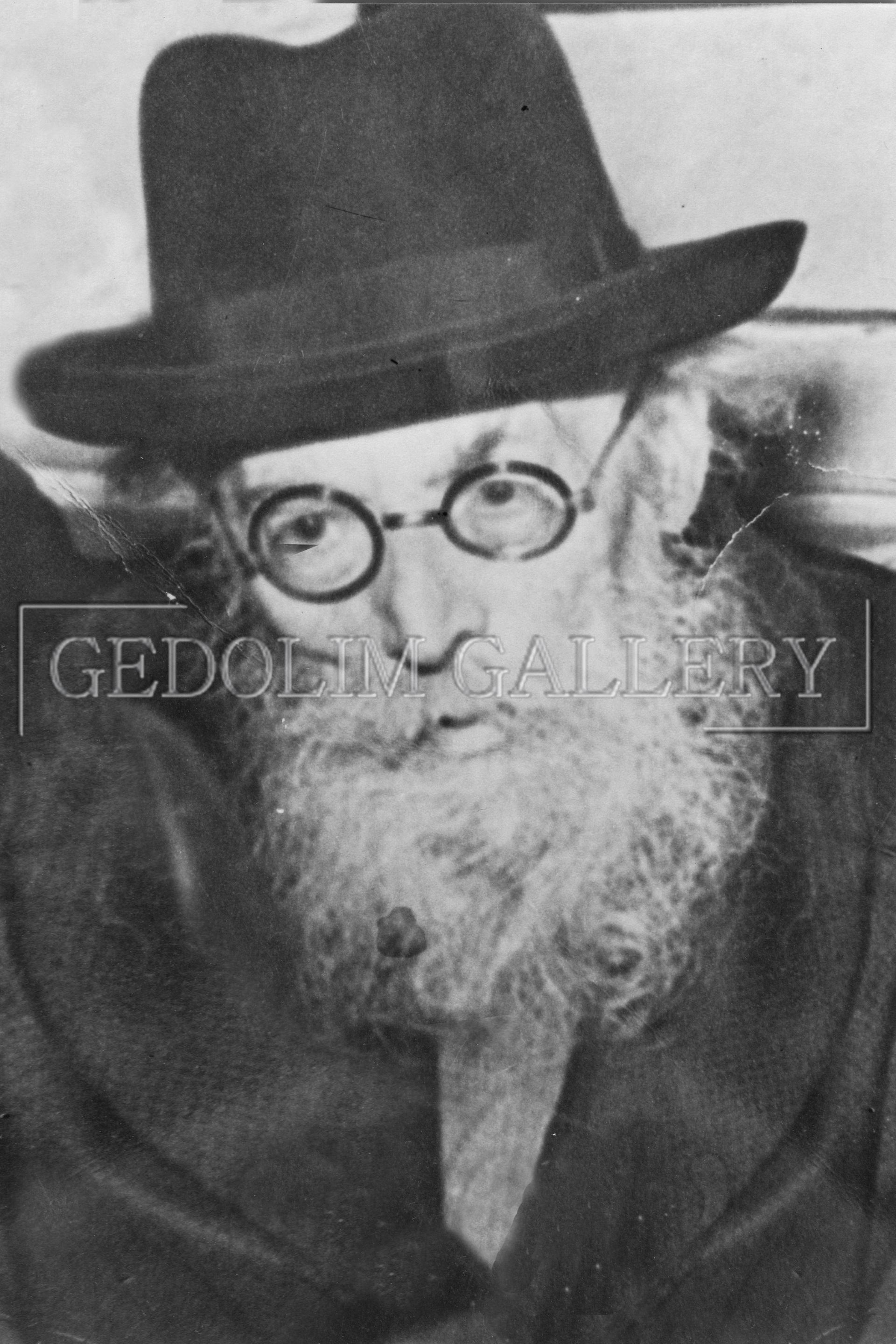 A man with a beard wearing a hat and glasses
