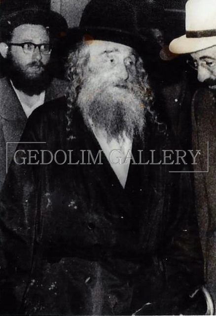 A black and white photo of a man with a beard and a hat by gedolin gallery