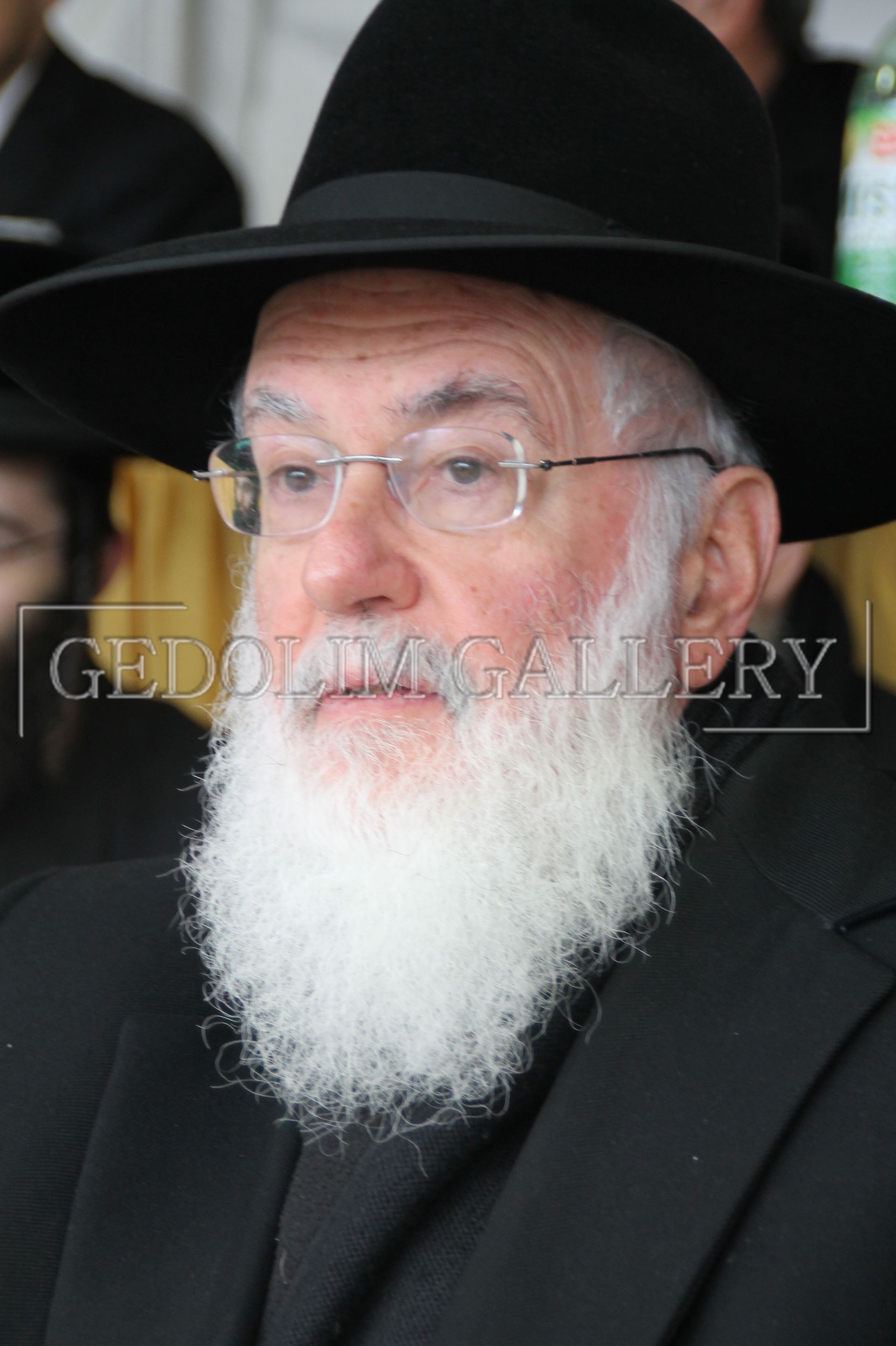 A man with a beard wearing a hat and glasses