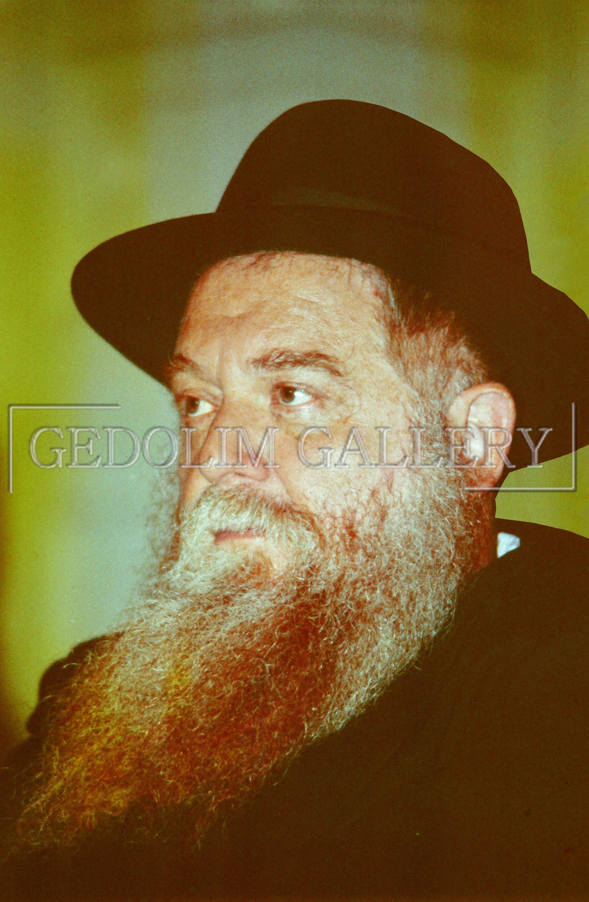 A man with a beard wearing a hat and a black shirt