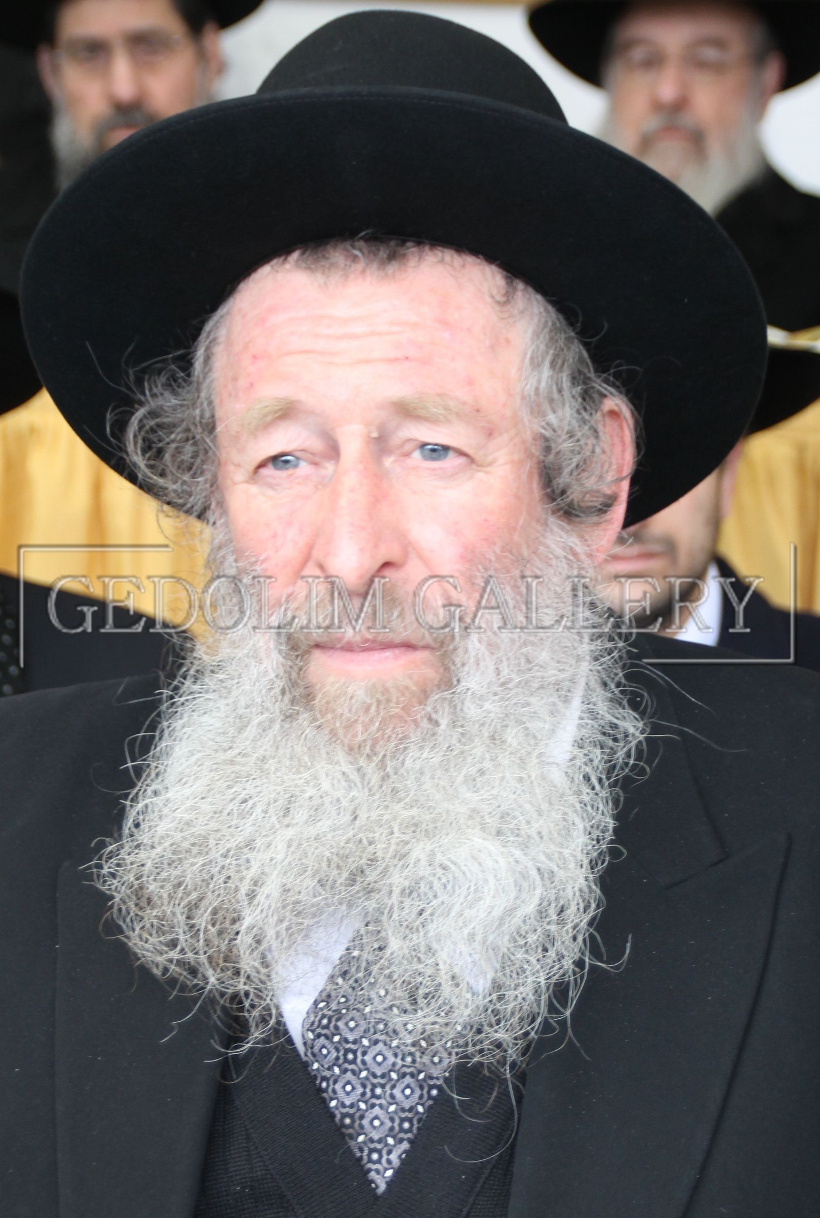 A man with a beard wearing a black hat