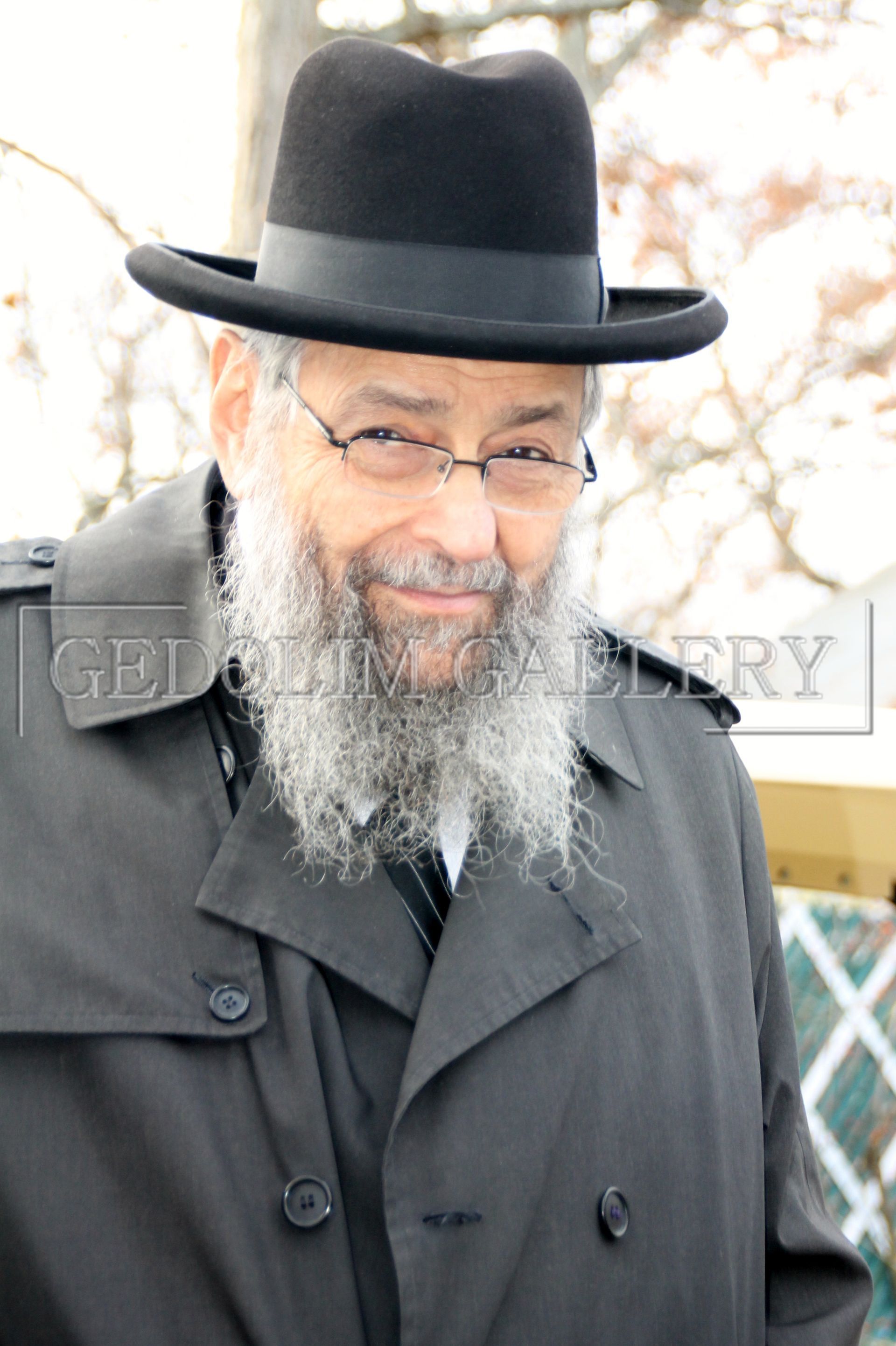 A man with a beard wearing a hat and glasses