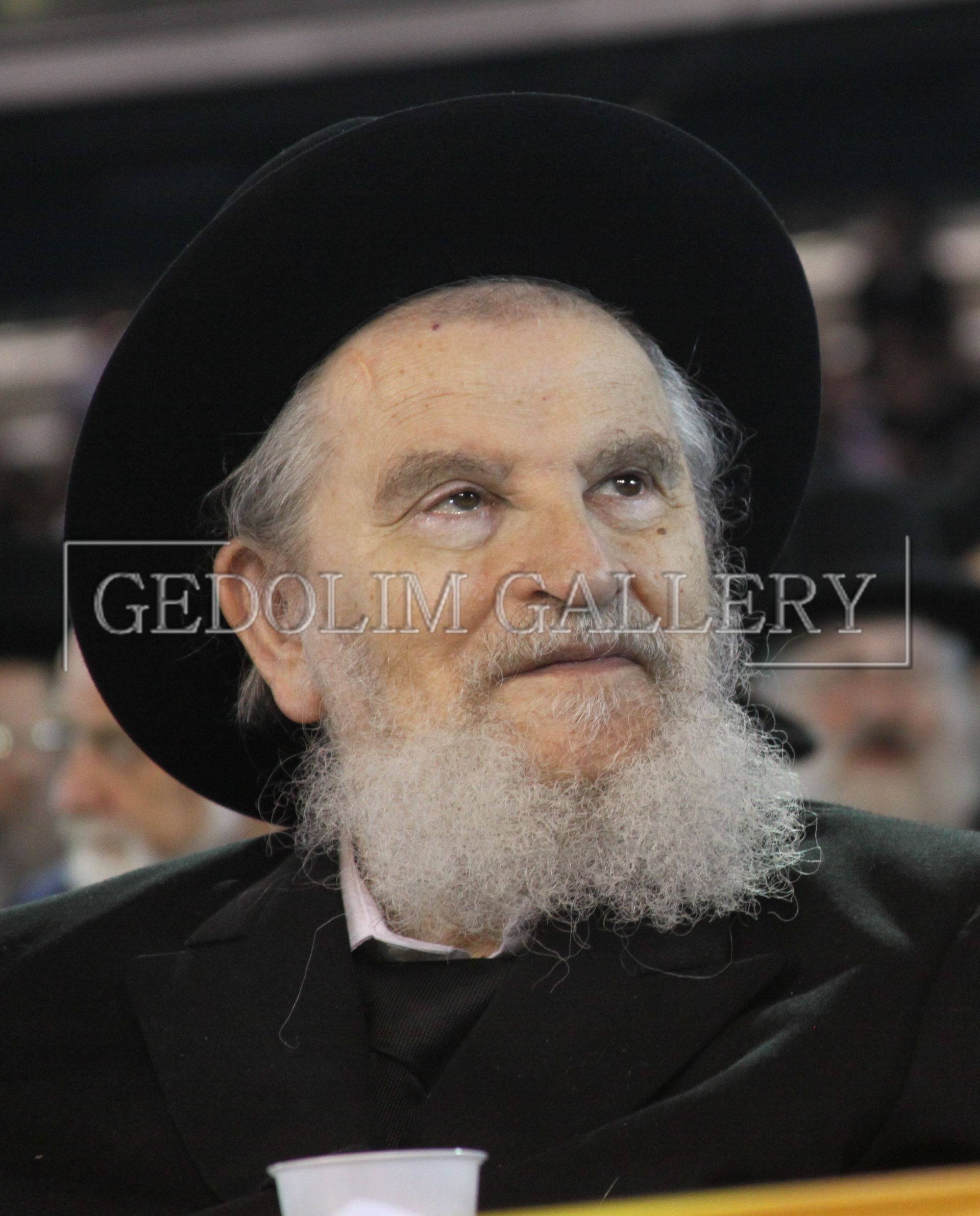 A man with a beard wearing a black hat