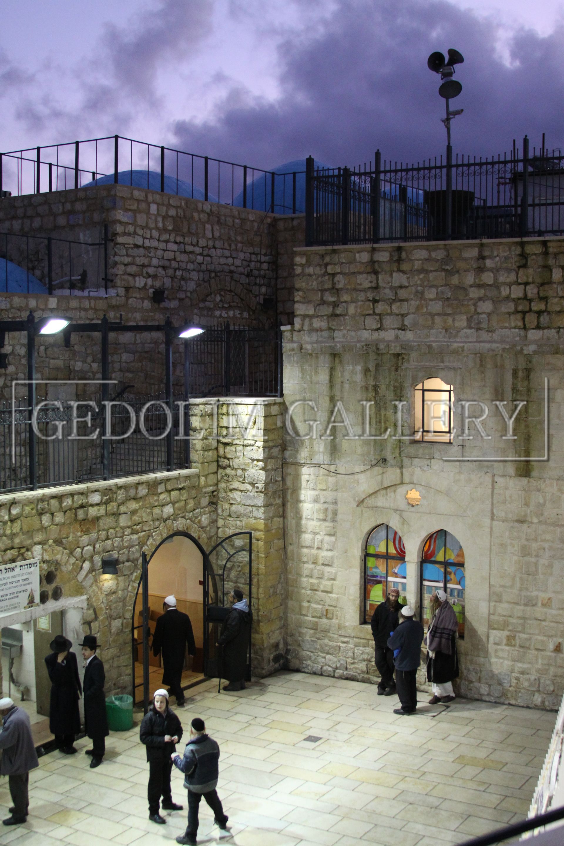 A group of people standing in front of a building with the word gallery on it