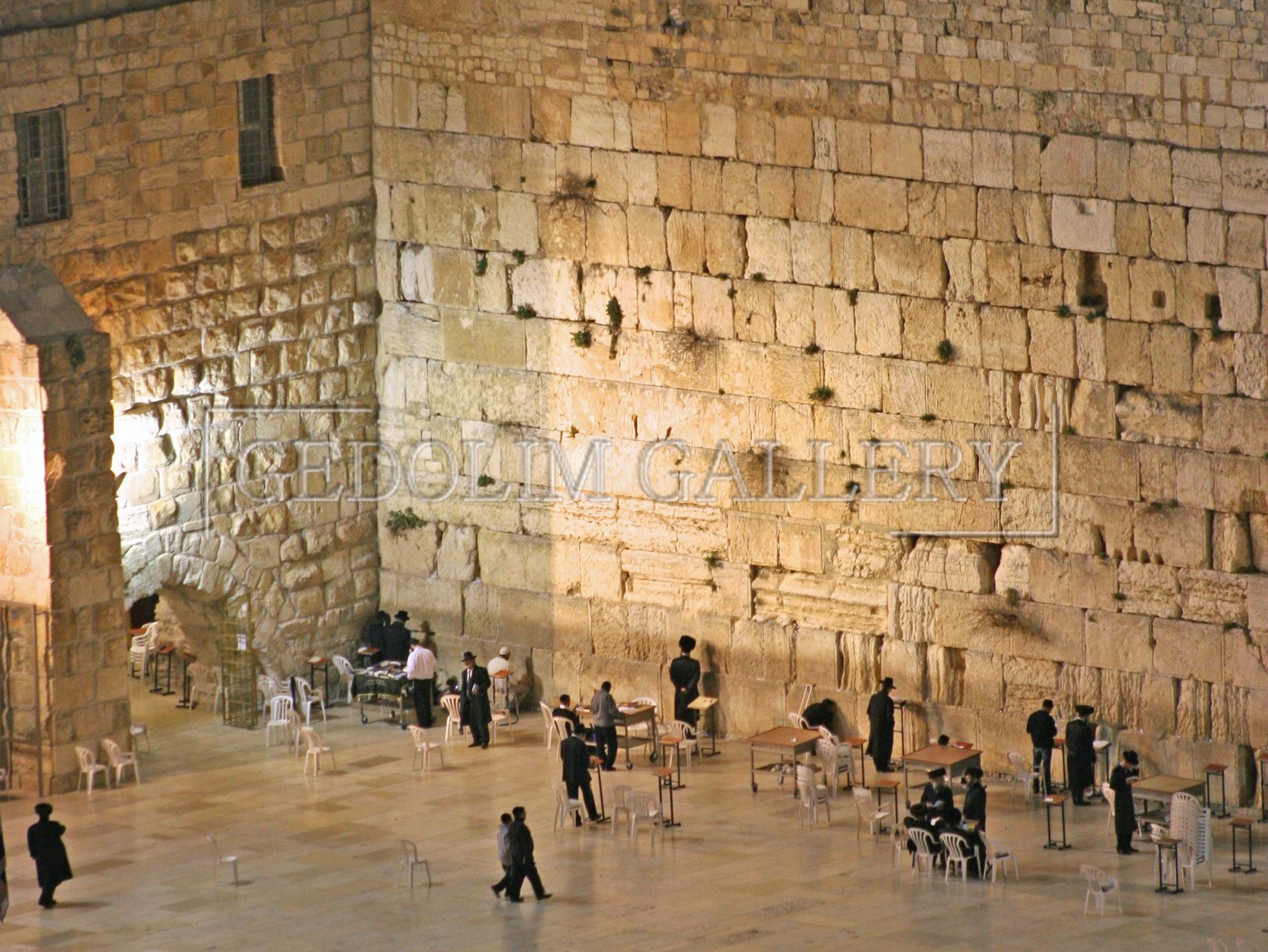 A group of people standing in front of a stone wall