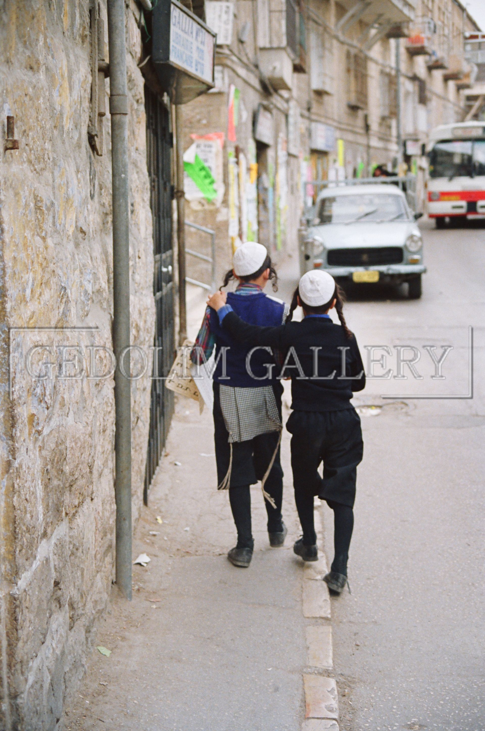 A couple of people walking down a street with the word gallery on the bottom