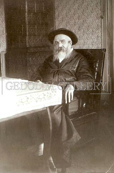A black and white photo of a man sitting in a chair.