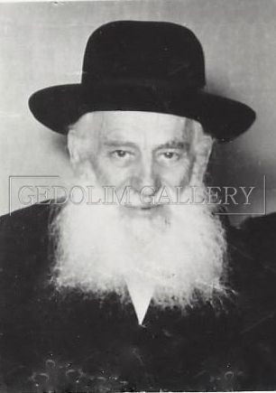 A black and white photo of a man with a beard wearing a hat.