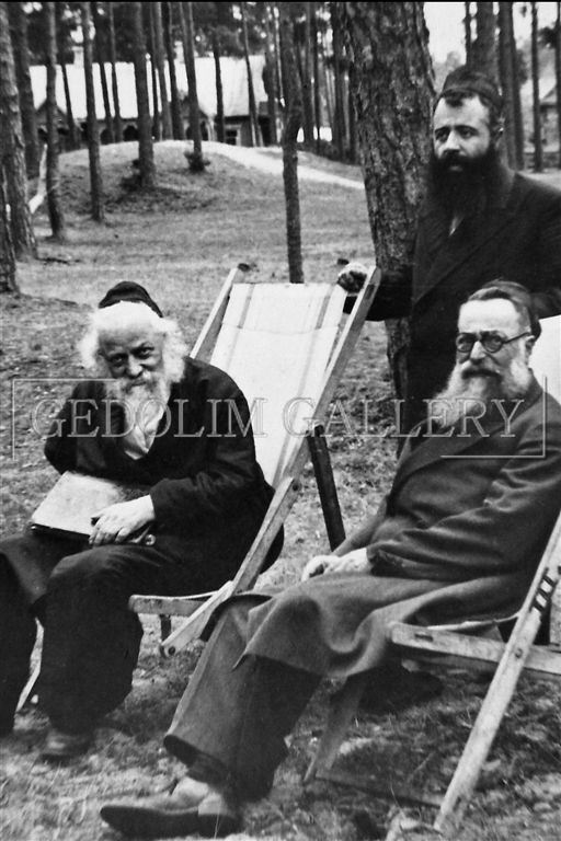 A black and white photo of three men sitting in lawn chairs