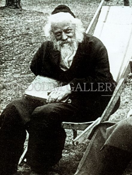 A man with a beard is sitting in a chair with the word gallery on the bottom