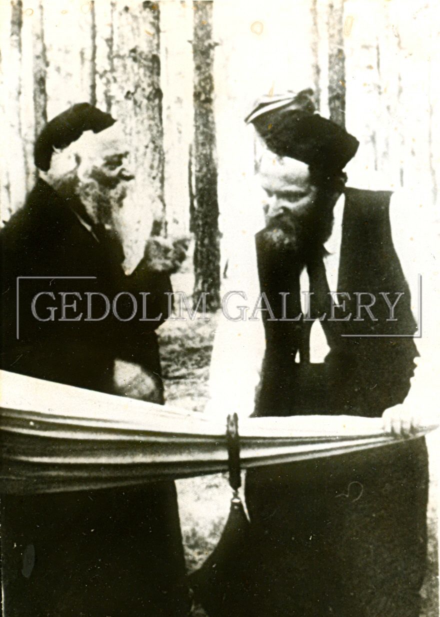 Two men are standing next to each other in a black and white photo that says gedole gallery