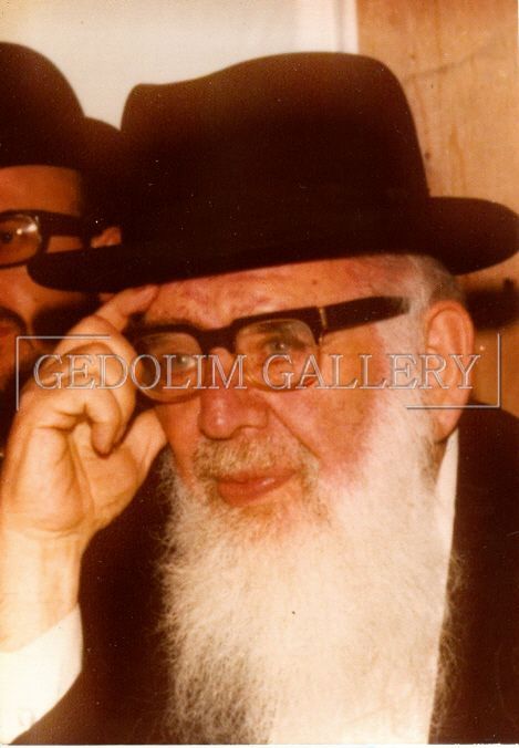A man with a beard wearing a hat and glasses
