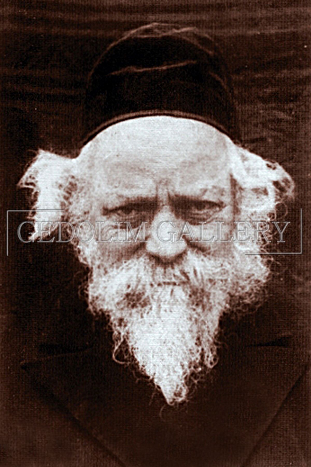 A man with a beard is wearing a black hat