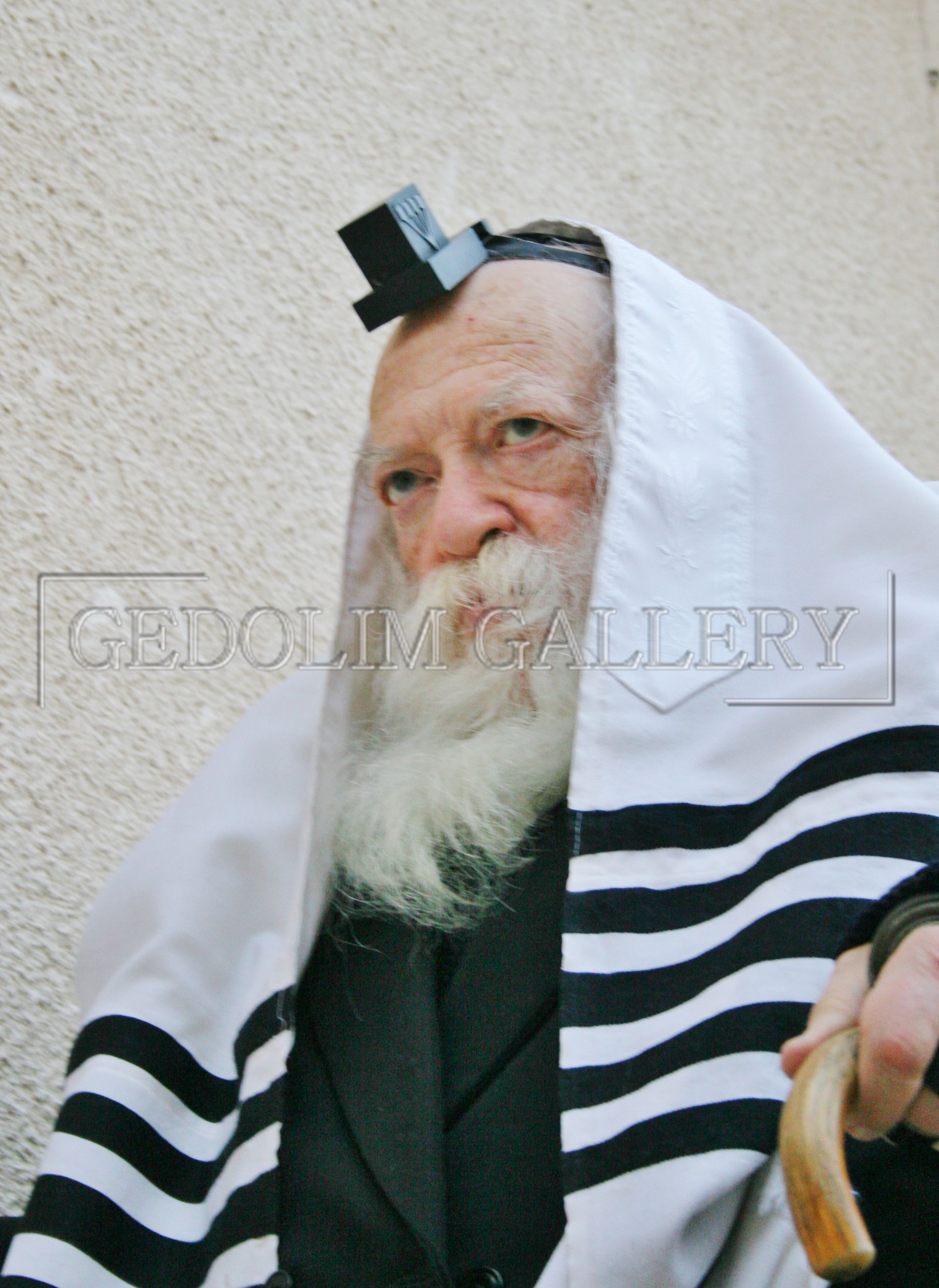 A man with a beard is wearing a black and white striped scarf