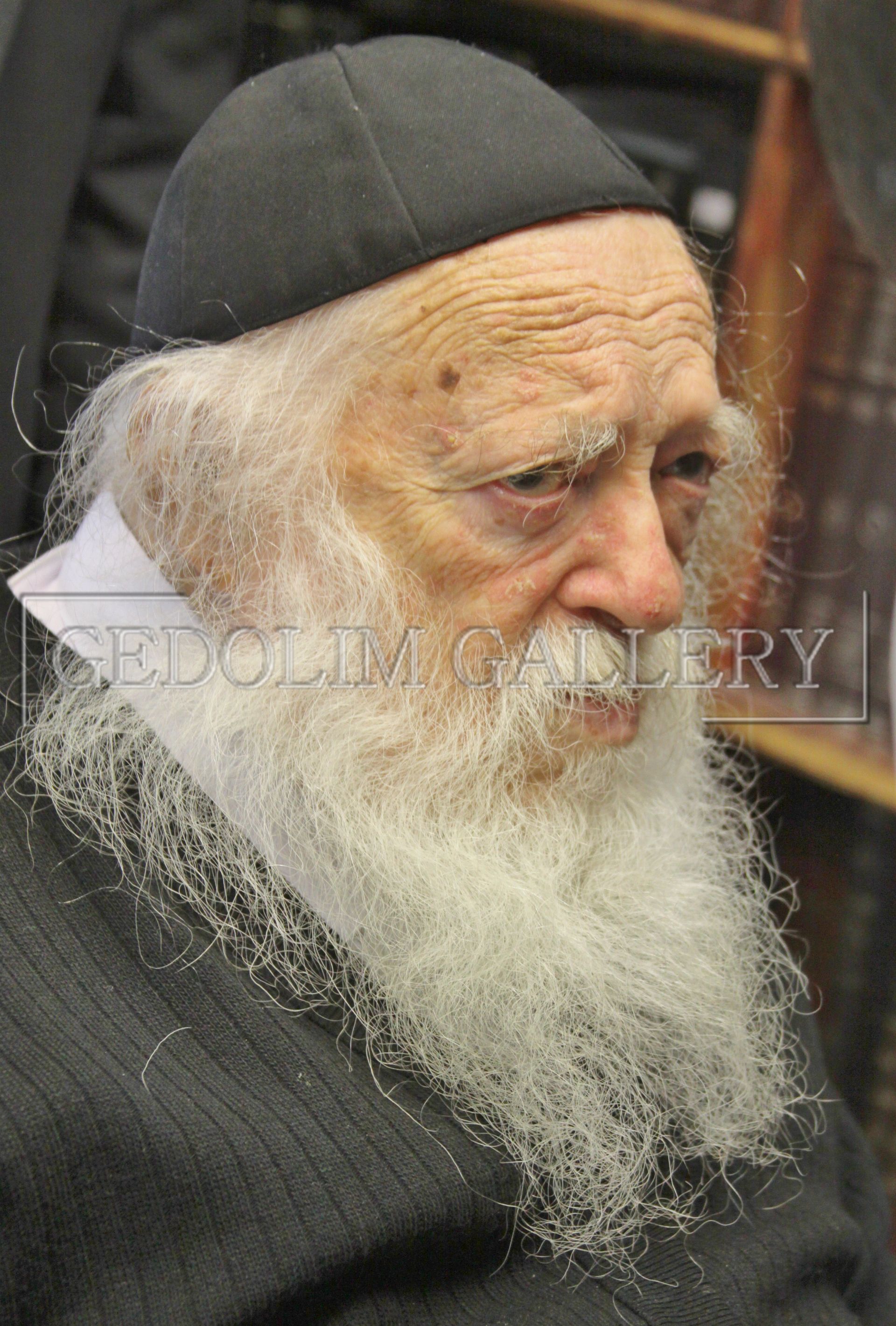 A man with a beard wearing a black hat