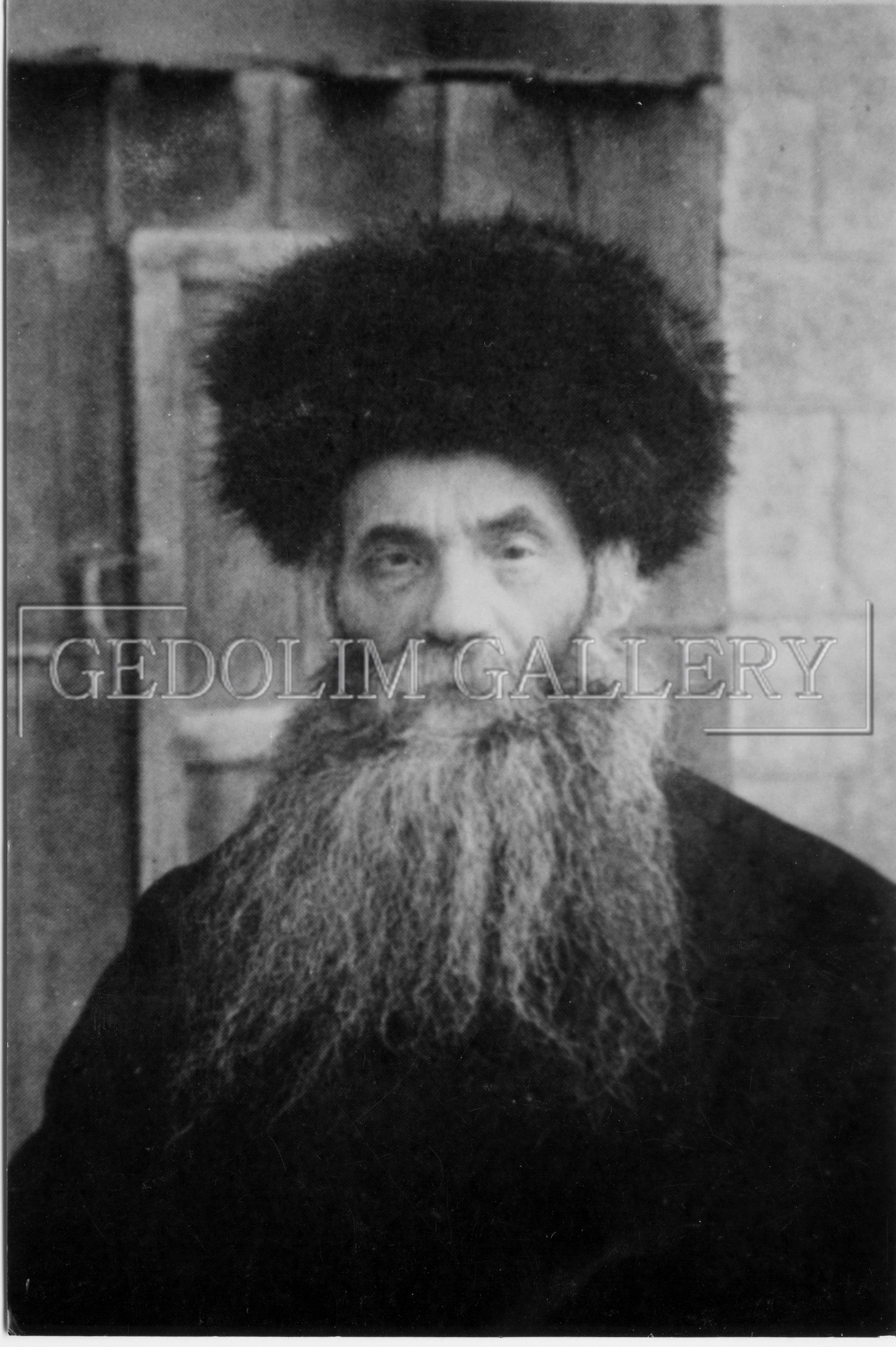 A black and white photo of a man with a beard and a hat.