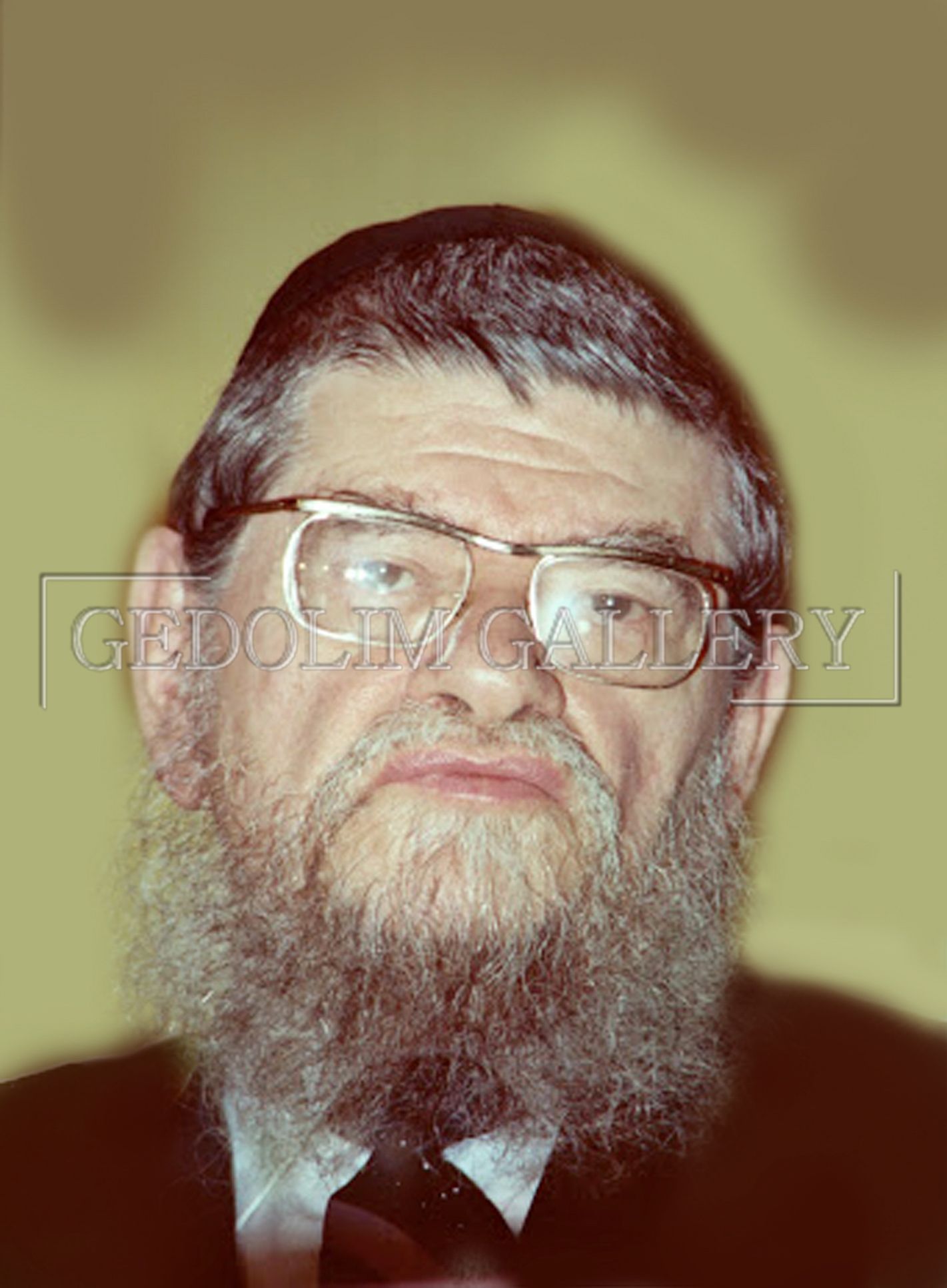 A man with a beard and glasses is wearing a suit and tie.