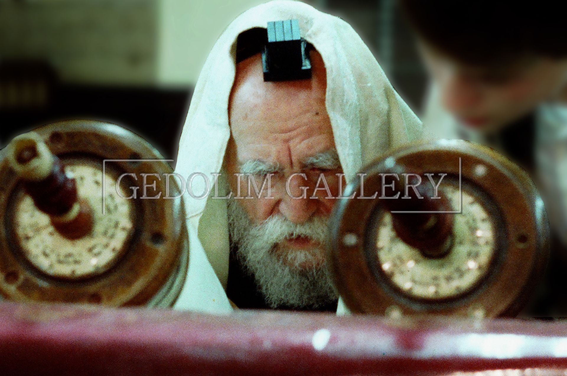 A man with a beard is reading the torah.