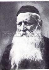 A black and white photo of a man with a beard and hat.