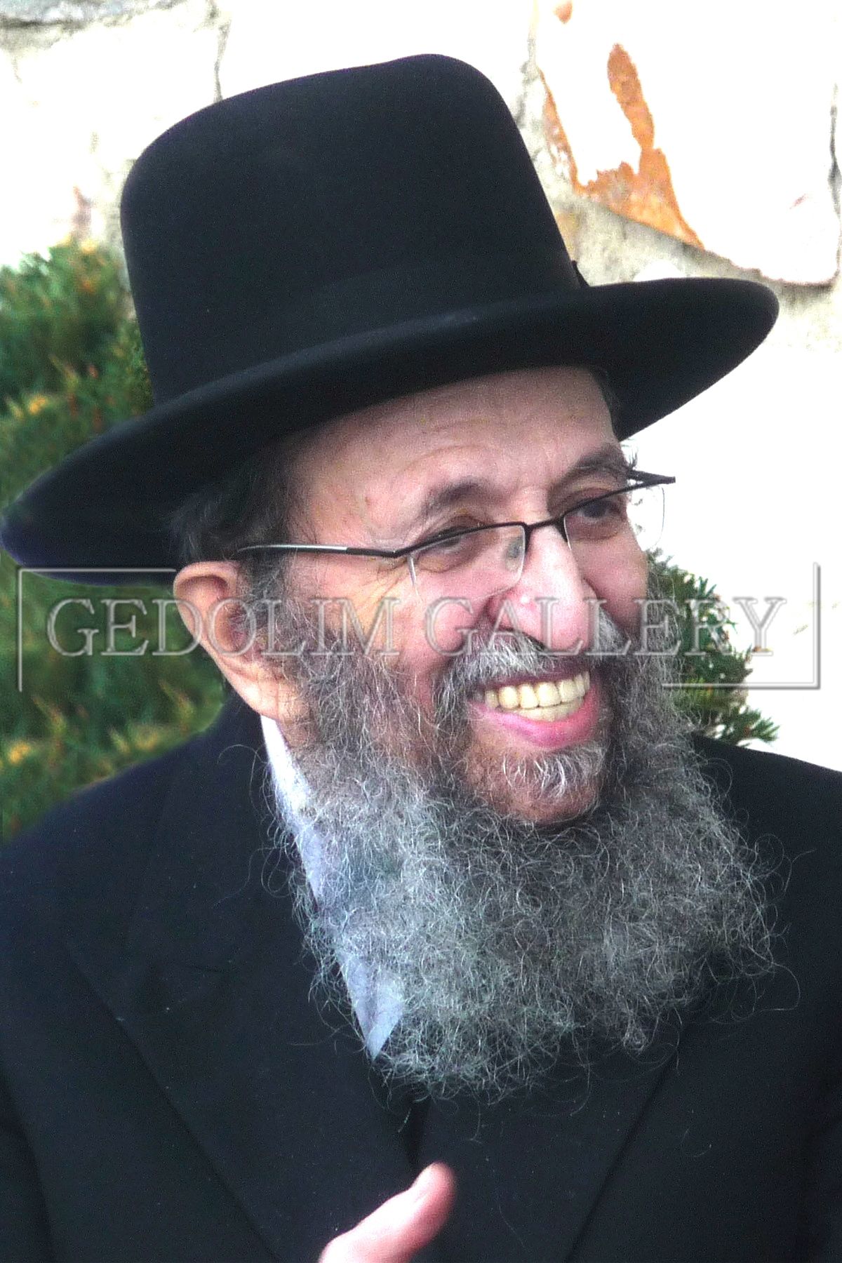 A man with a beard wearing a black hat and glasses