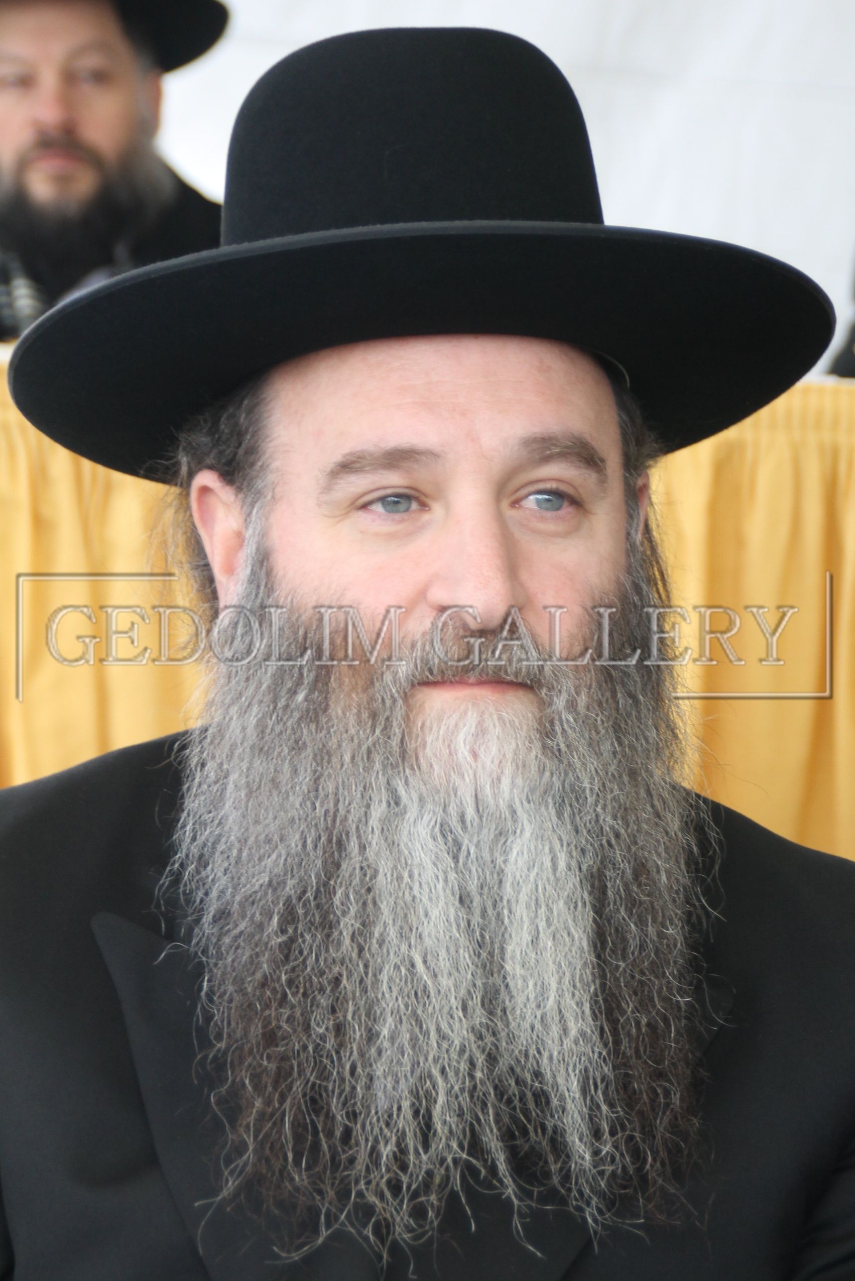 A man with a beard wearing a black hat