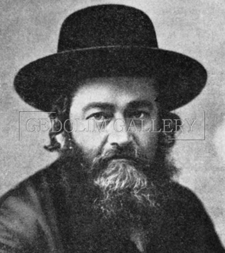 A black and white photo of a man with a beard wearing a hat.