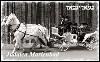 A black and white photo of a horse drawn carriage.