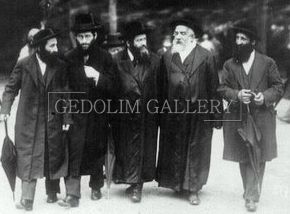 A group of men are walking down a street in a black and white photo.