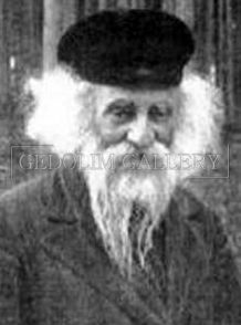 A black and white photo of an older man with a beard and hat.