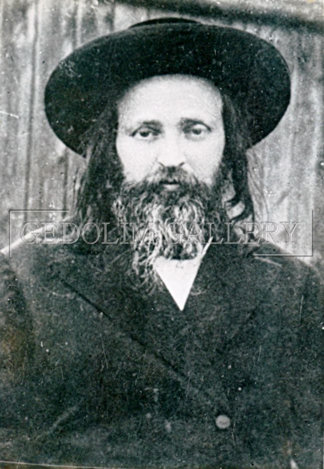 A black and white photo of a man with a beard wearing a hat.