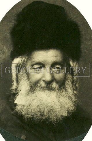A black and white photo of a man with a beard wearing a fur hat