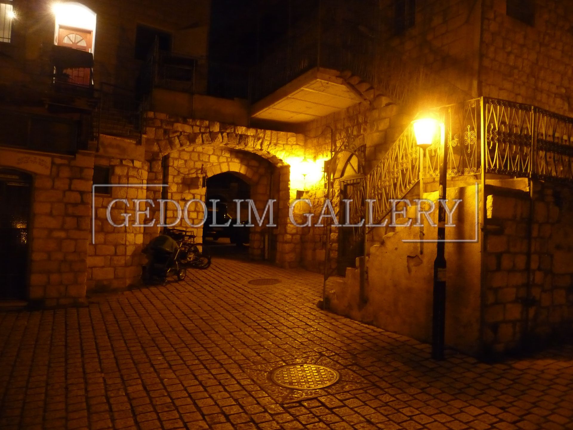 A photo of a street at night is taken by gedolin gallery