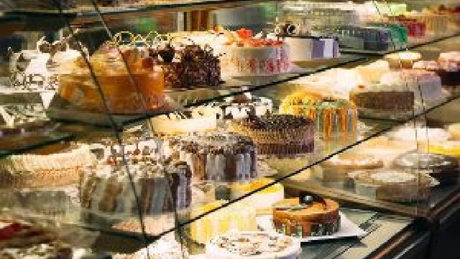 A Display Case Filled With Lots Of Cakes In A Bakery — Macleay Air In Macksville, NSW