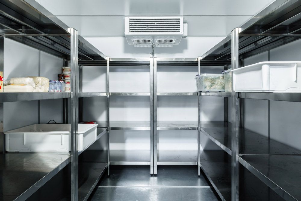 An Empty Refrigerator With Stainless Steel Shelves In A Kitchen — Macleay Air In West Kempsey, NSW