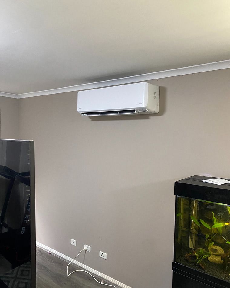 A Living Room With A TV, Fish Tank, And Air Conditioner — Macleay Air In West Kempsey, NSW