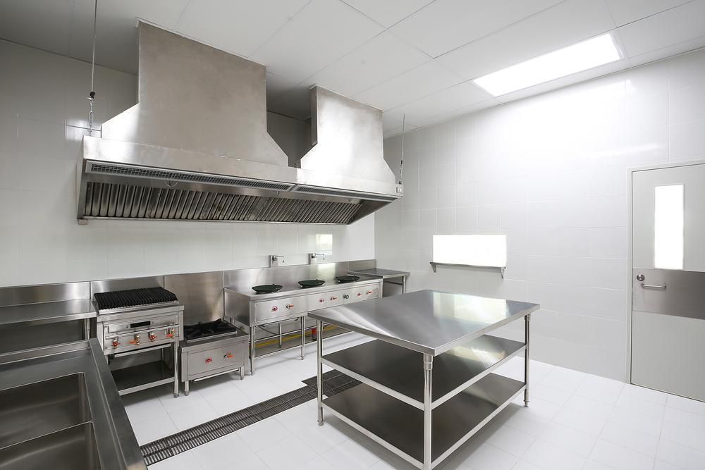 A Kitchen With Stainless Steel Appliances And A Table — Macleay Air In West Kempsey, NSW
