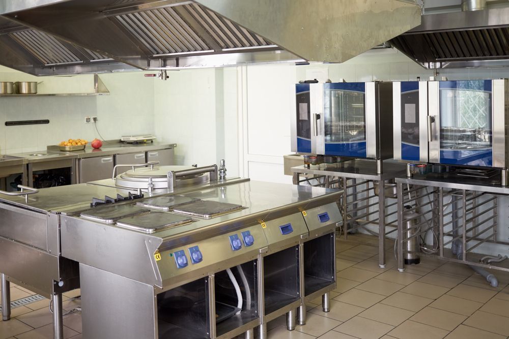 A Large Commercial Kitchen With A Lot Of Stainless Steel Appliances — Macleay Air In West Kempsey, NSW